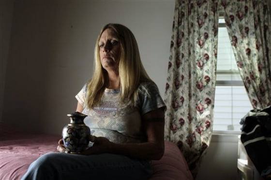 Sue Tayon of Overland, Mo. holds an urn containing the ashes of her daughter Nikki, 28, who died of an overdose of heroin. The mother said the heroin was 90 percent pure.
